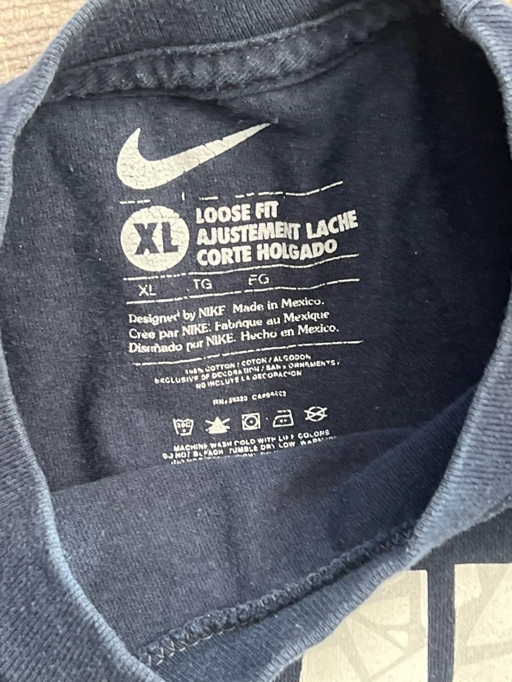 Nike Navy Short Sleeve Tee with White Vertical Graphic and Blue Swoosh. K24